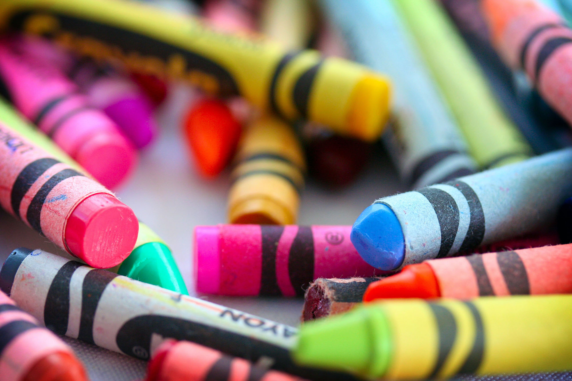 Different color crayons in a pile