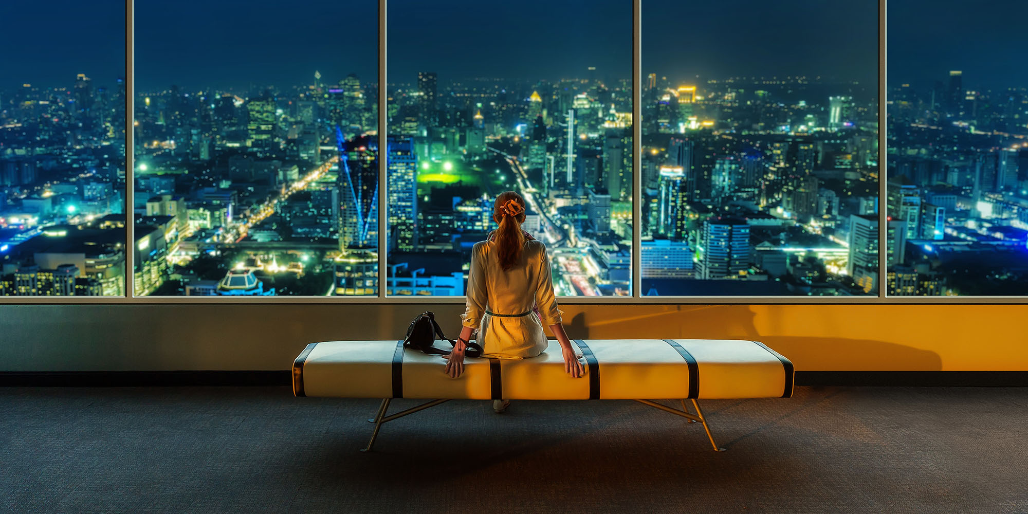 Woman looking out of skyscraper window