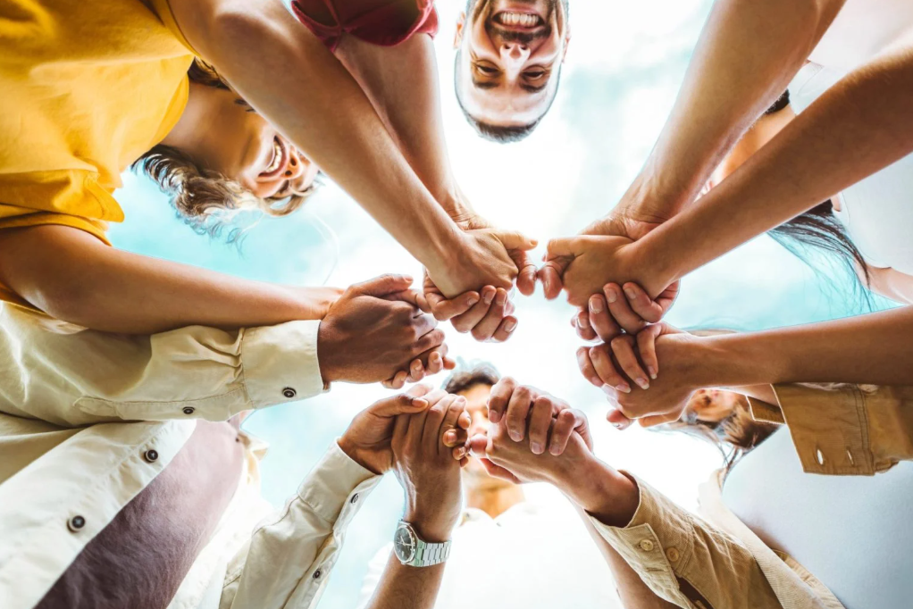 group putting hands in middle