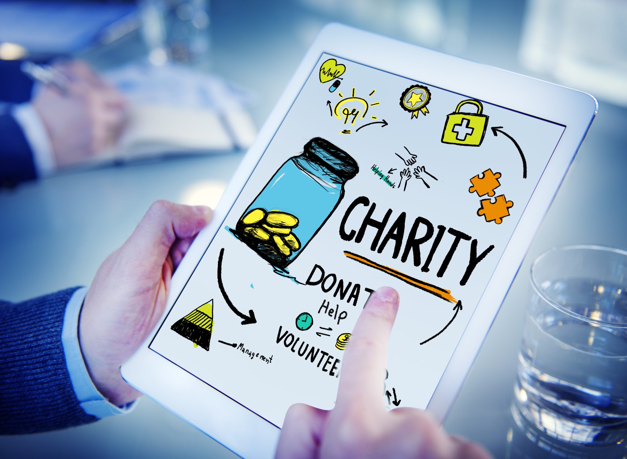 Tablet with a cartoon-style graphic and the word "Charity" showing
