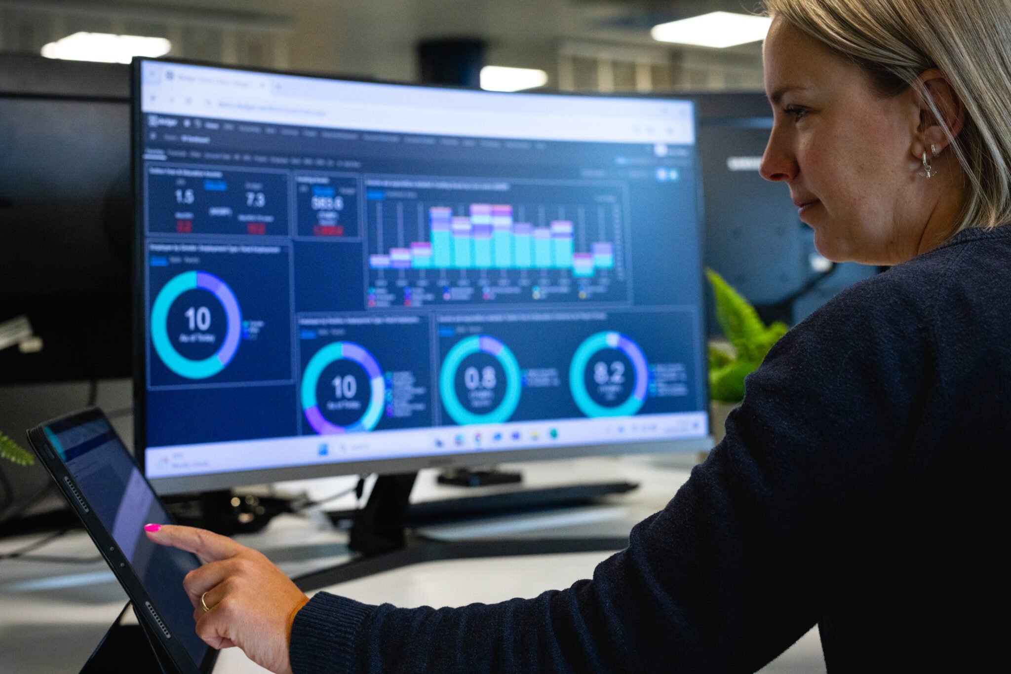 Woman on computer with xledger product on screen