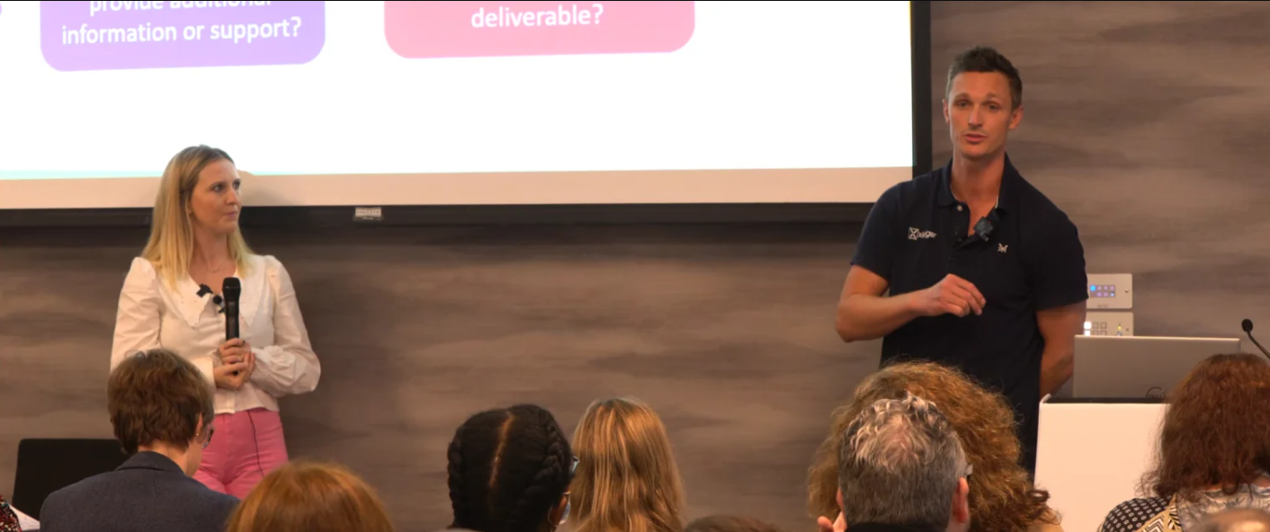 two people at a speaker session