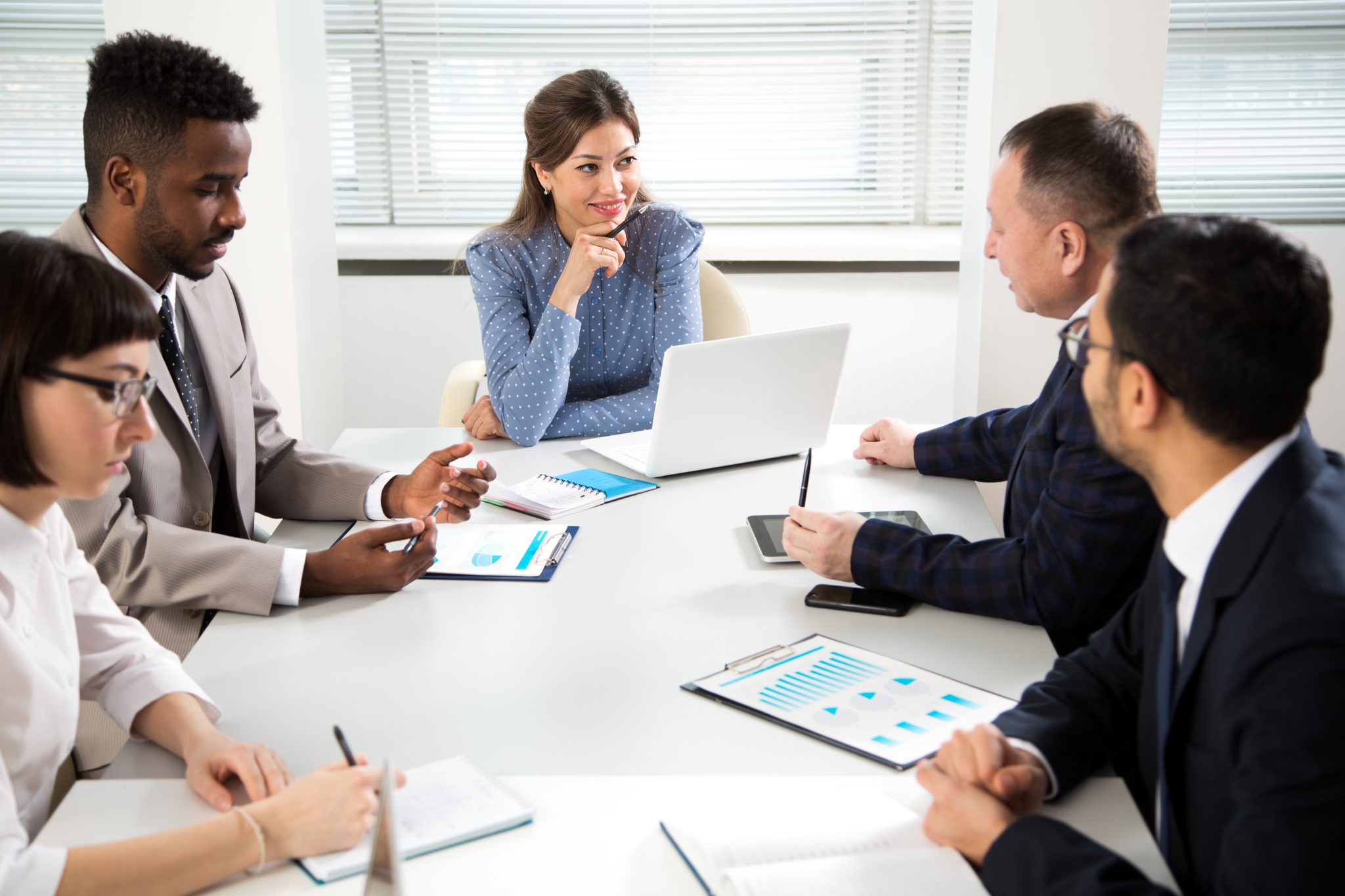 Work meeting setting with four accountants discussing finance