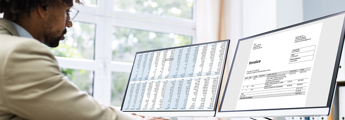 Worker at desk analysing spreadsheets