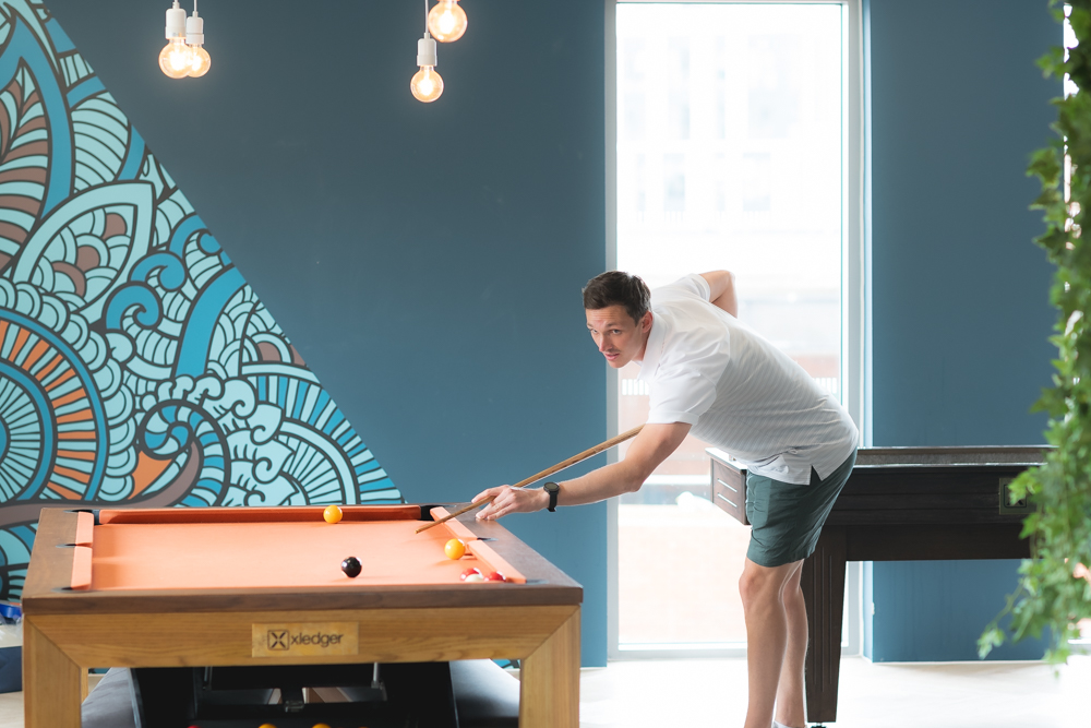 Xledger colleague playing pool