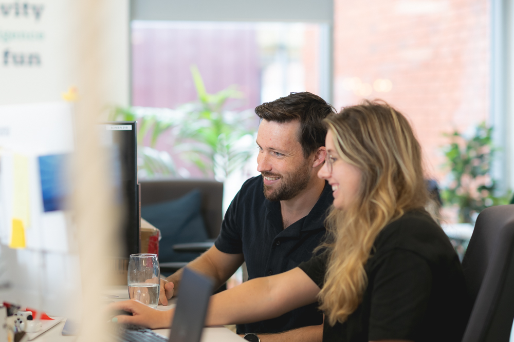 Man and woman working on computer