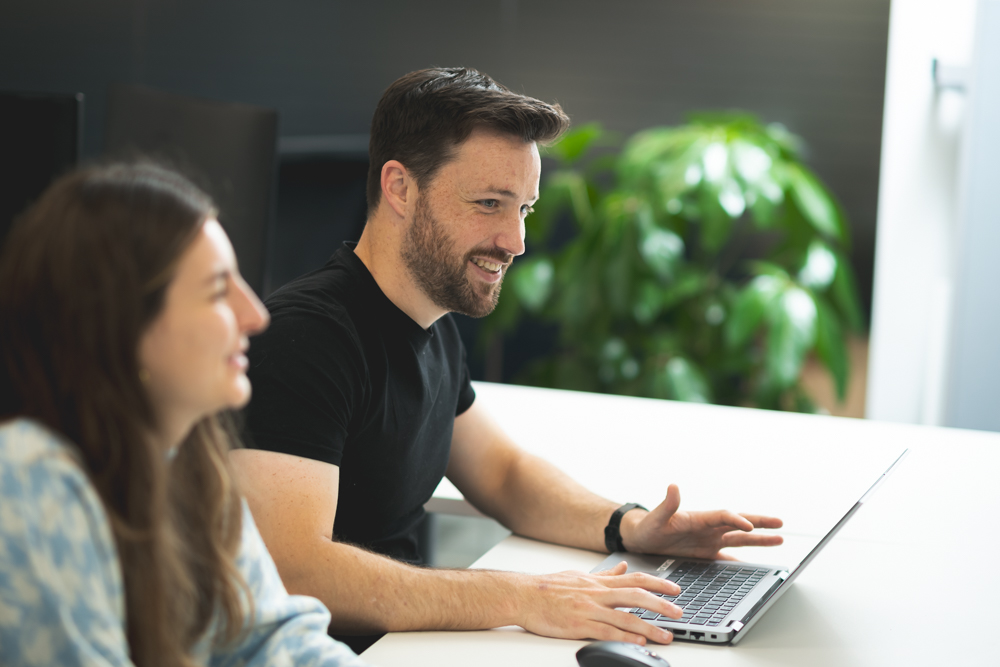 Man working on computer smiling