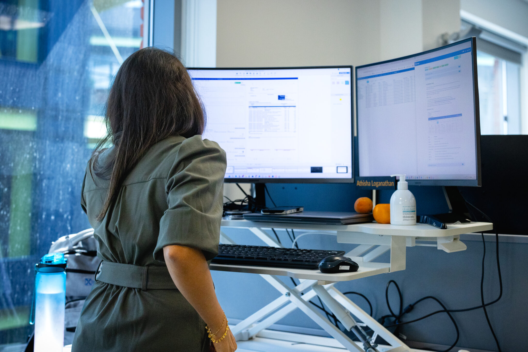 Woman on computer looking at invoice