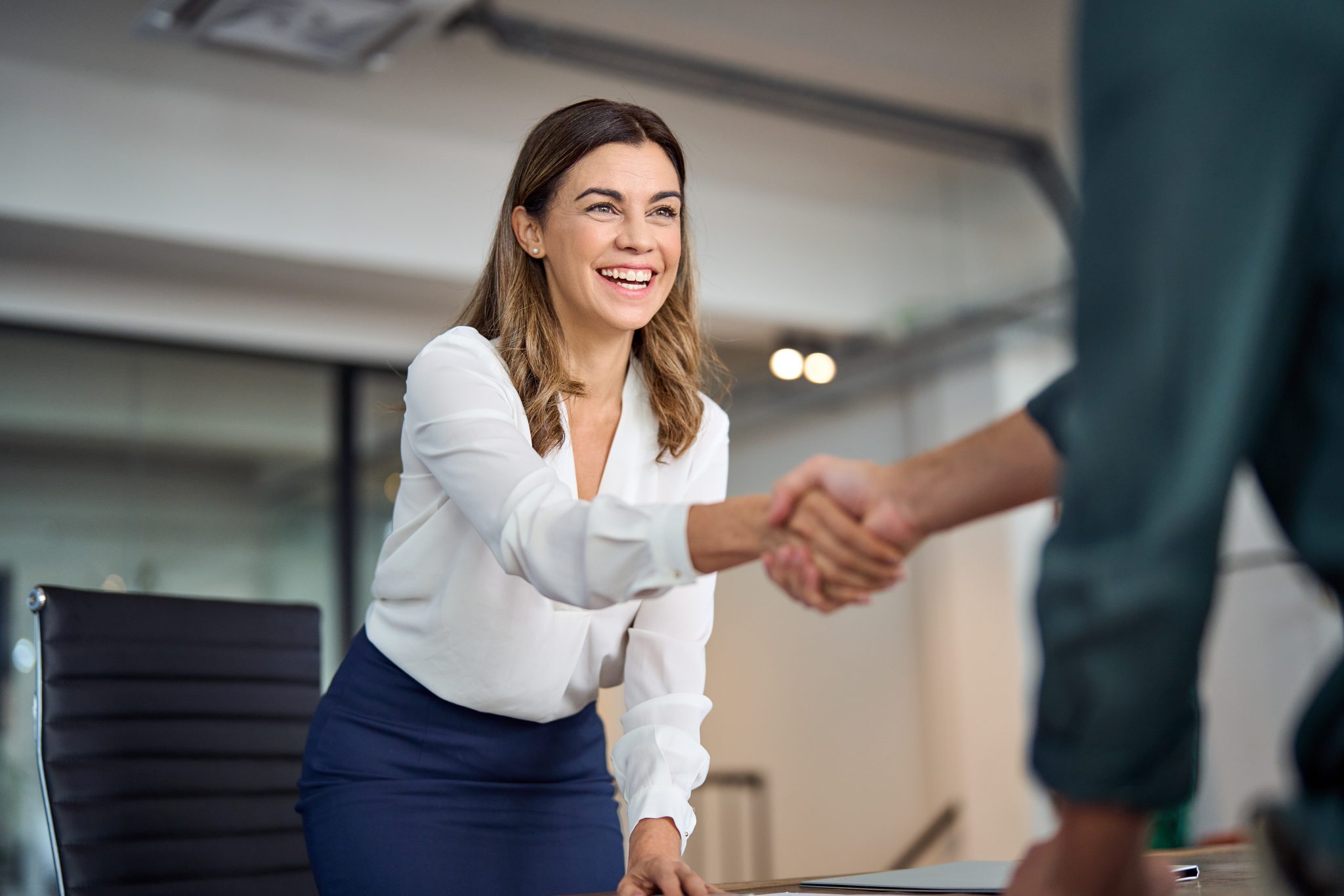 Woman shaking hands with a man