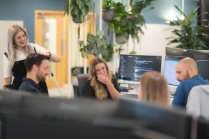 people talking and working at desks