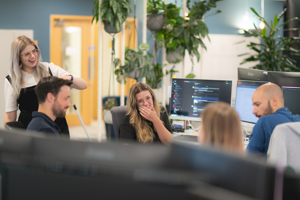 people talking and working at desks