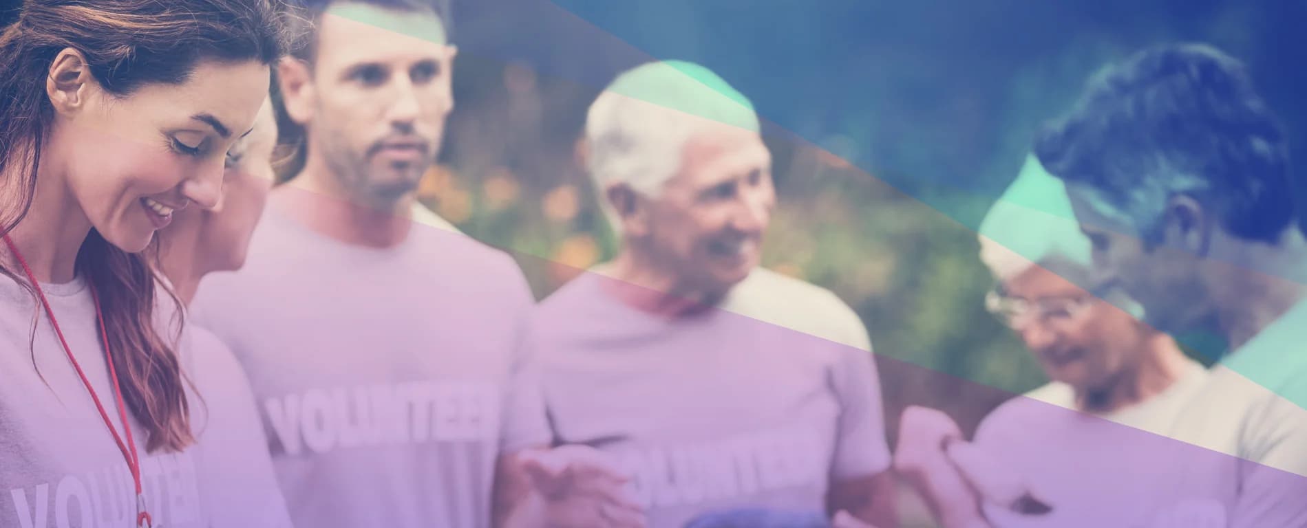 Group of volunteers wearing matching shirts standing together outdoors, smiling and interacting, with a soft blue and purple overlay.