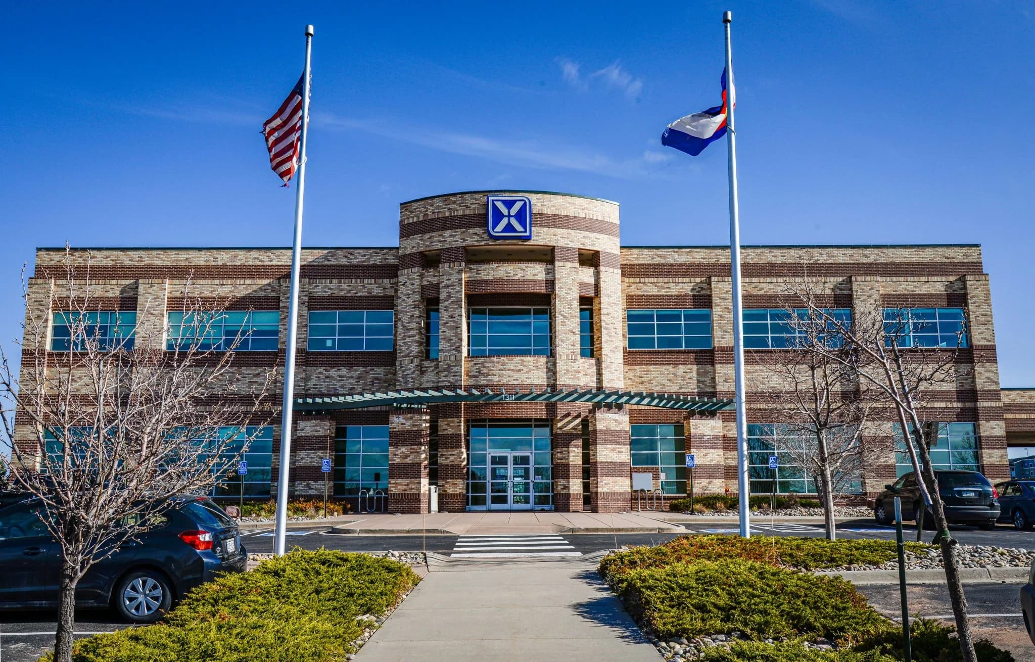 Xledger office building in Colorado Springs with flags and main entrance visible