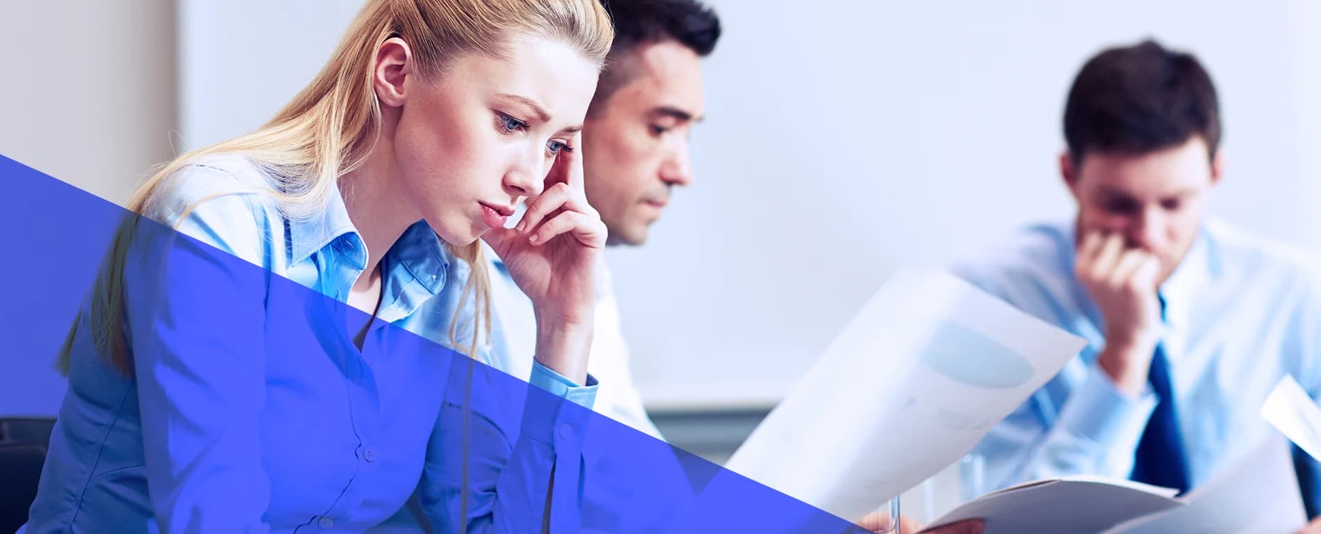 Team reviewing documents and analyzing reports in an office setting
