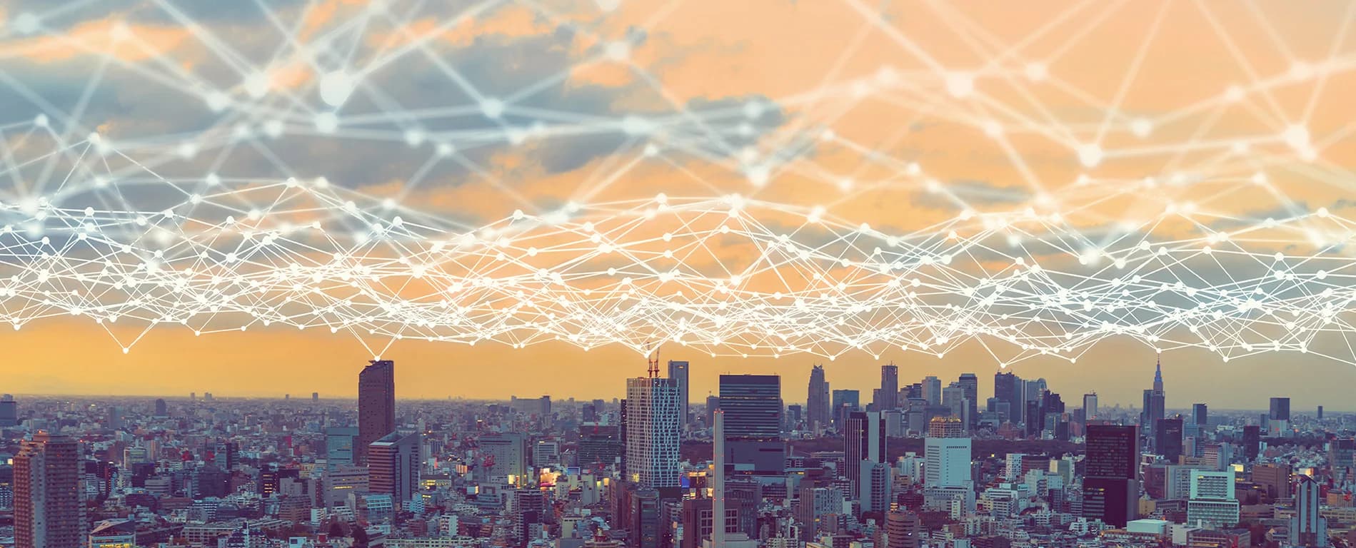 City skyline with a digital network overlay connecting buildings.