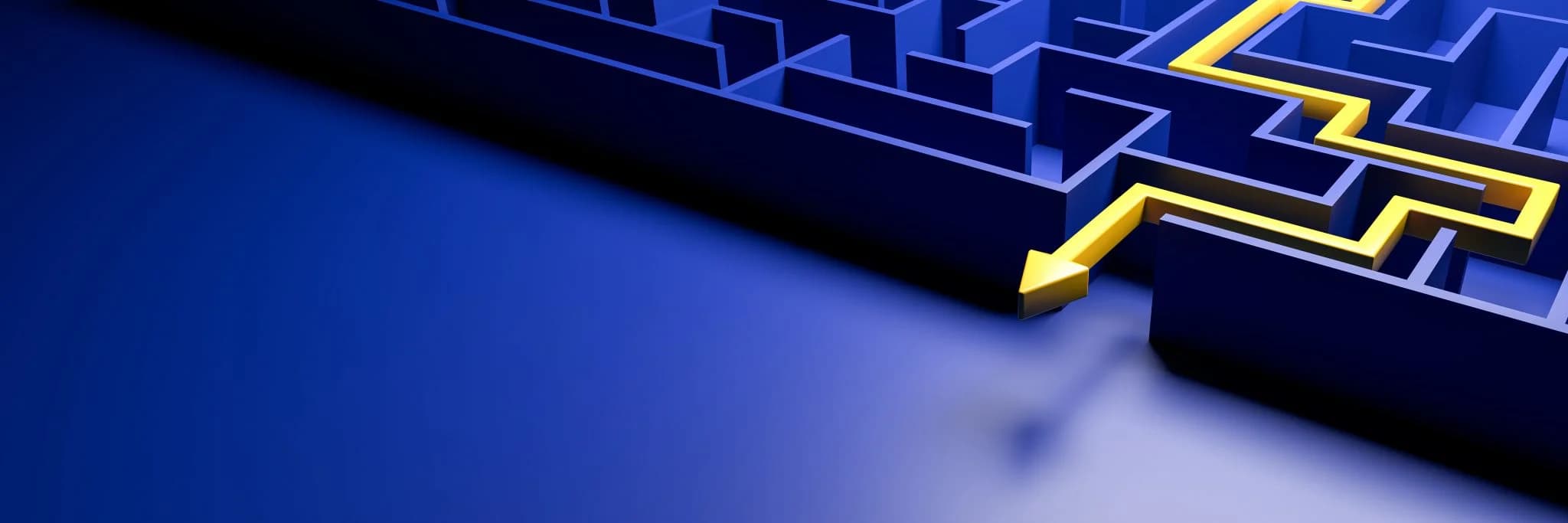 A blue maze viewed from above with a bright yellow arrow tracing a path through it, symbolizing finding a solution or direction.