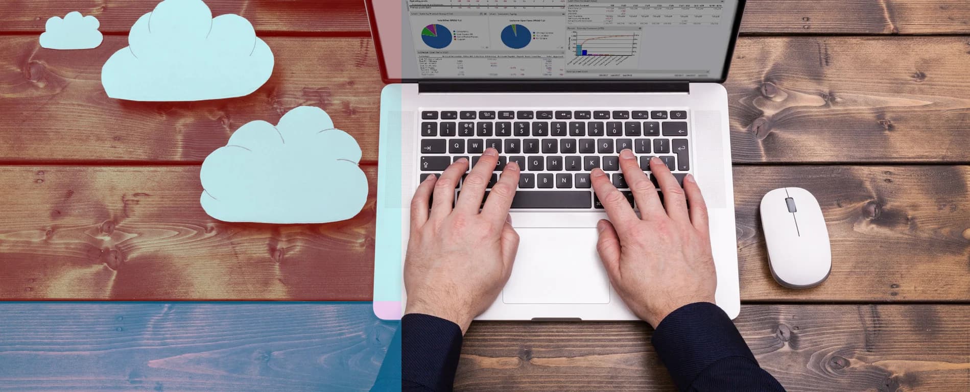 Person typing on a laptop with charts on screen, surrounded by cloud icons on a wooden desk, representing cloud computing and data analysis